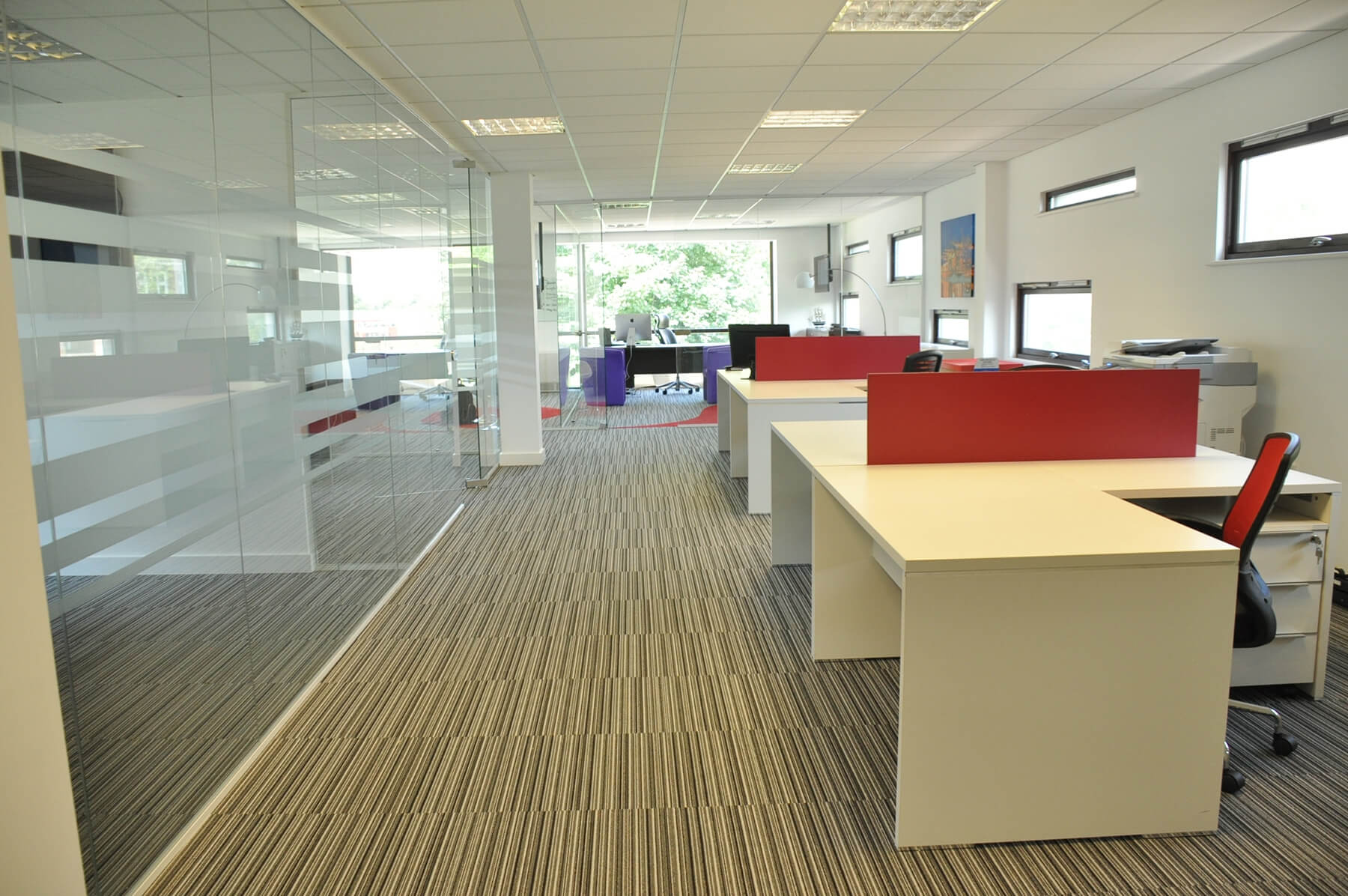Large office space separated using glass partitions Large office space separated using glass partitions