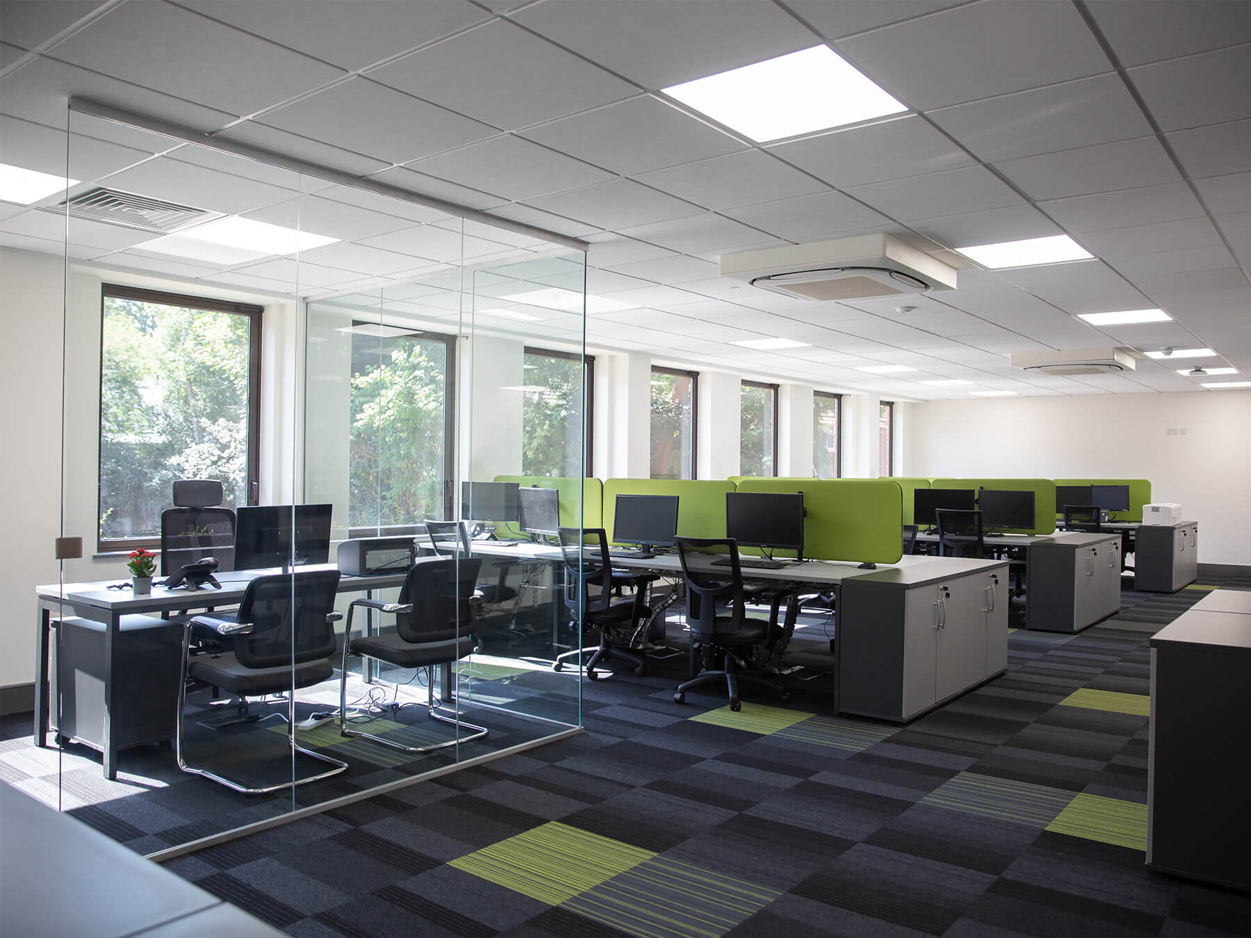 Office space with co working area and private space with glass partitions Office space with co working area and private space with glass partitions