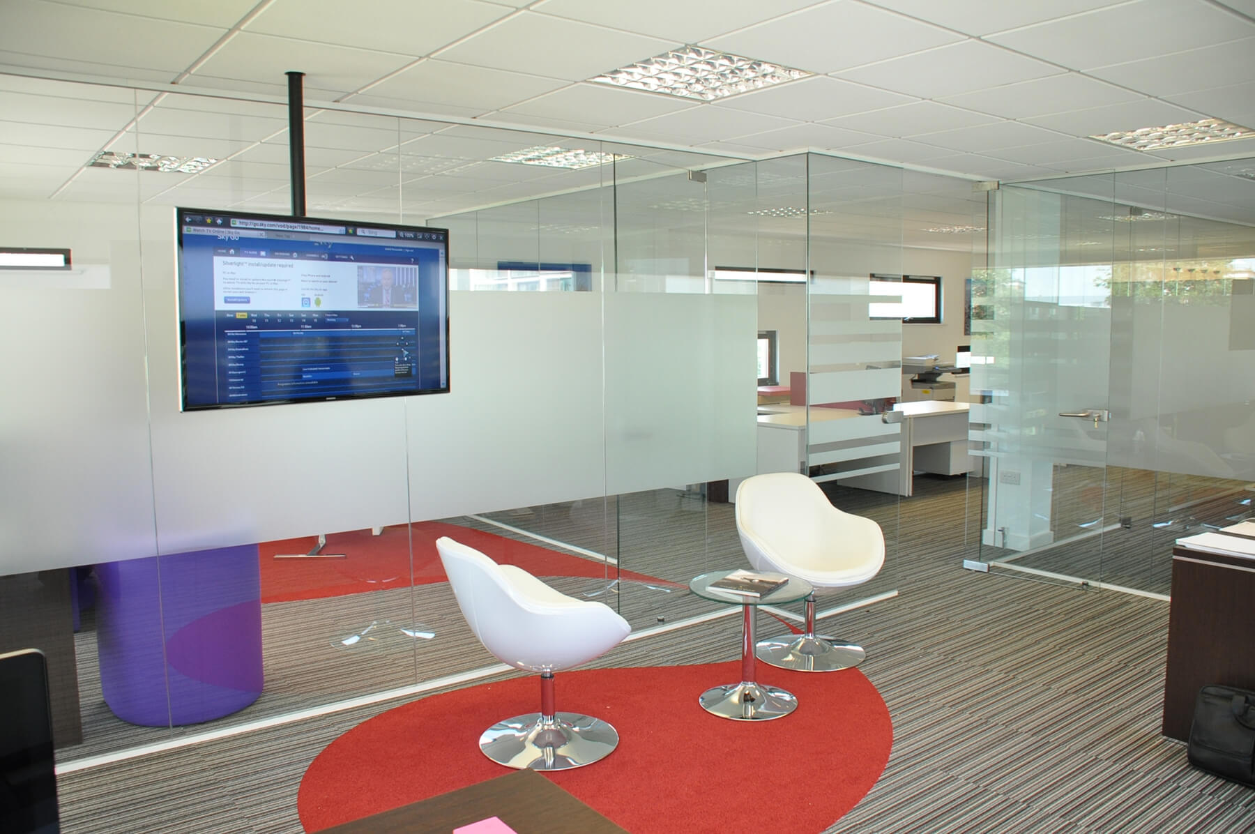 Office space with frameless glass partitions Office space with frameless glass partitions