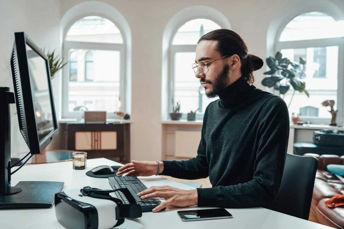 Bearded office worker with long hairs types on key Bearded office worker with long hairs types on key