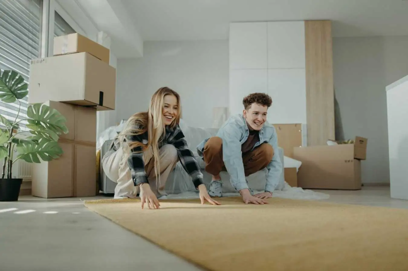 Cheerful young couple in their new apartment roll Cheerful young couple in their new apartment roll