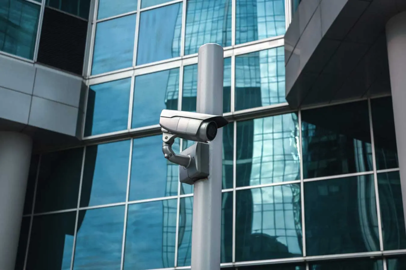 External surveillance camera against glass buildin The Pros and Cons of Office Surveillance