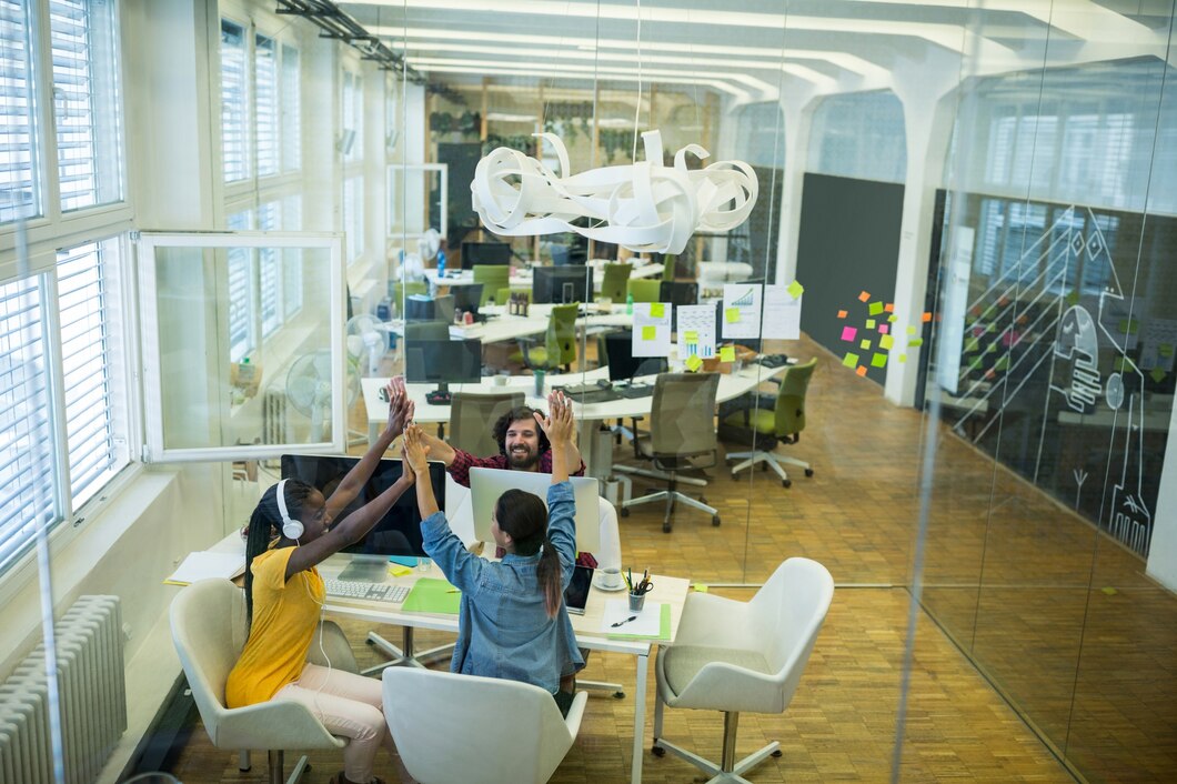 Group graphic designers giving high five each other Group graphic designers giving high five each other