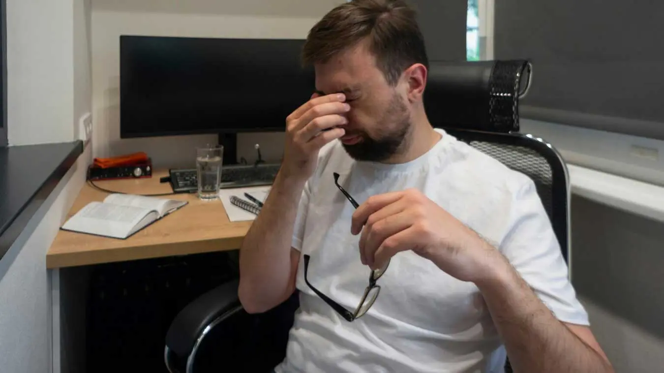 Man taking off glasses tired of work bad vision Man taking off glasses tired of work bad vision