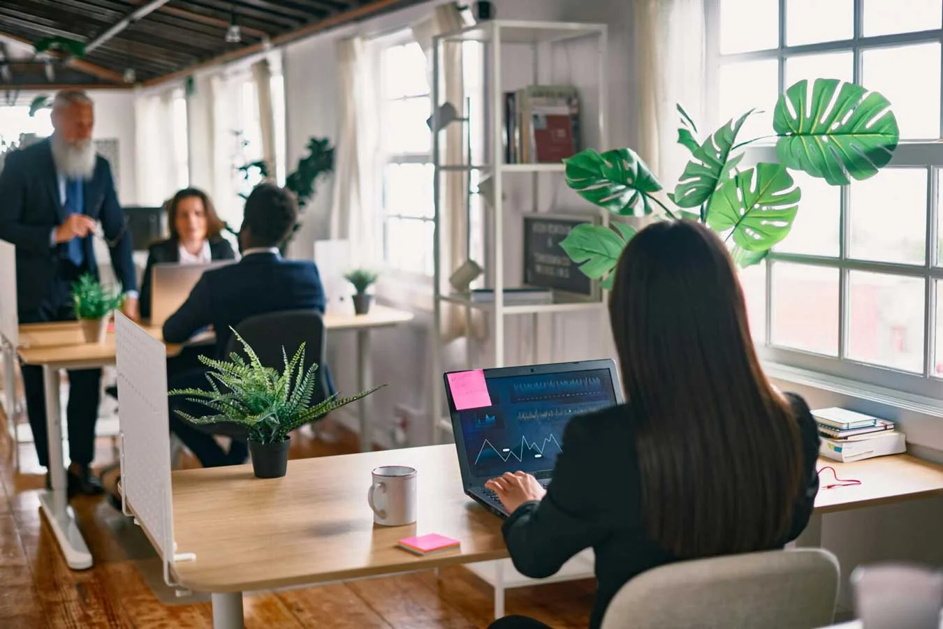 Multiracial business people working inside hedge.