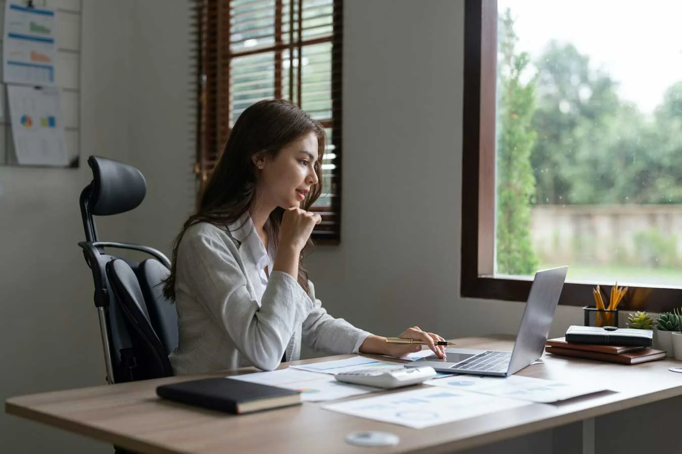 Woman accountant using calculator and computer in office finance and accounting concept  